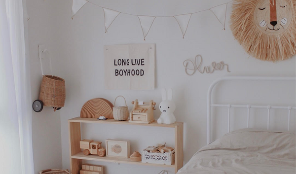 A neutral kids bedroom with wooden and rattan decor. Perfect for play based learning. Read more about it at Little Gatherer Children's Boutique NZ